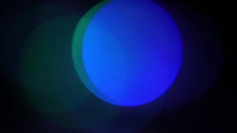 Large diffuse bokeh light emission on a black screen Stock Footage 309428528