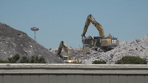 Large Digger removing dirt from huge dump, wide shot, HD Stock Footage 123617701