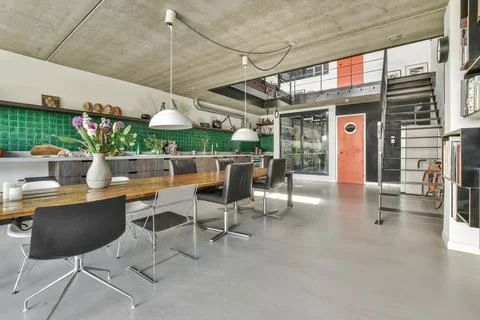 A large dining room with a long table and chairs 写真素材