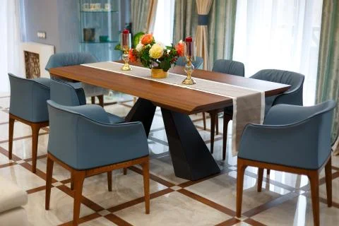 Large dining table with a tablecloth and two candles. Stock Photos