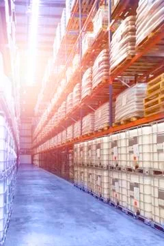 Large distribution warehouse interior, pallets and boxes of cargo. Stock Photos