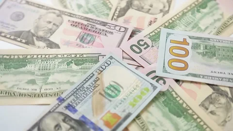 Large dollar bills are scattered in a mess and revolve in a circle. Stock Footage 159150682