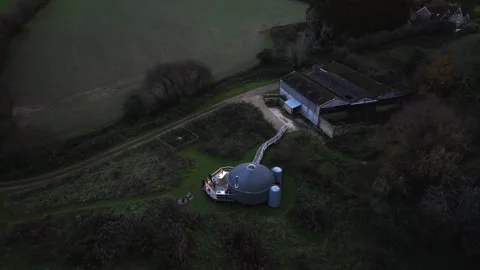 A large dome-shaped structure is in the middle of a field Stock Footage 295371271
