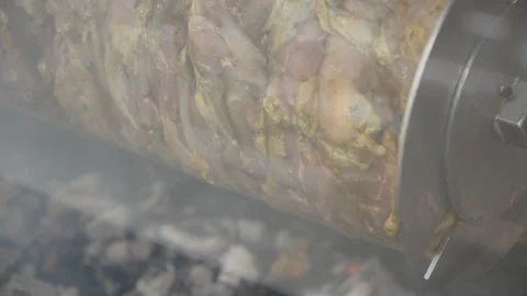 Large Doner skewer spinning over coals in a local restaurant. shawarma drill spi 動画素材 102189816