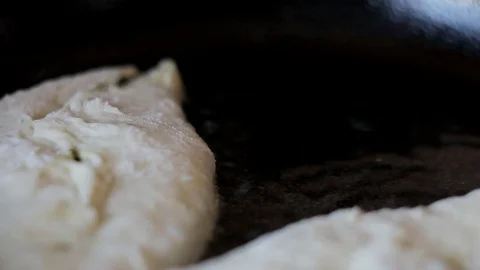 Large donuts are fried in boiling oil. Traditional Russian cuisine. Stock Footage 128241609