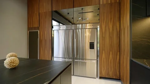 Large double refrigerator of silver colour in exclusive modern space with black Stock Footage 257609499