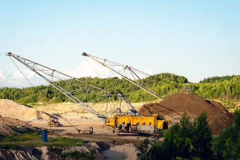 Large dragline excavator working in an open?pit mine under clear blue sky Stock Photos