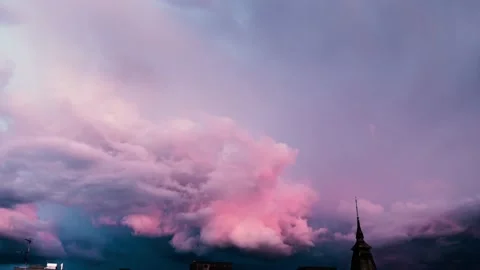 Large dramatic thunder clouds rolling through the sky during pink sunset, Stock Footage 138520627