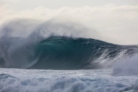 Large dramatic Wave breaking in hawaii over coral reef Stock Photos