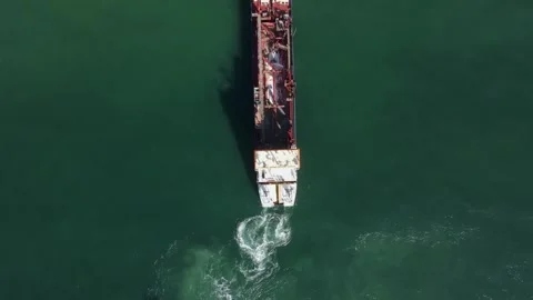 A large dredging barge pumps tons of sand and water to create a sand island in Stock Footage 306585685