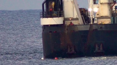 Large dredging ship connects with dredging pipe on ocean to pump sand on Stock Footage 119997525