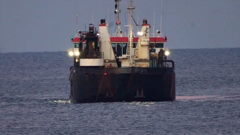 Large dredging ship connects with dredging pipe on ocean to pump sand on Stock Footage 119997550