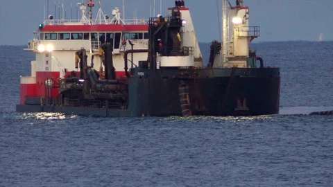 Large dredging ship connects with dredging pipe on ocean to pump sand on Stock Footage 119997913