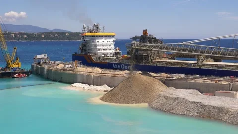 Large dredging vessel and coastal construction site with turquoise water in 4K Stock Footage 323080971