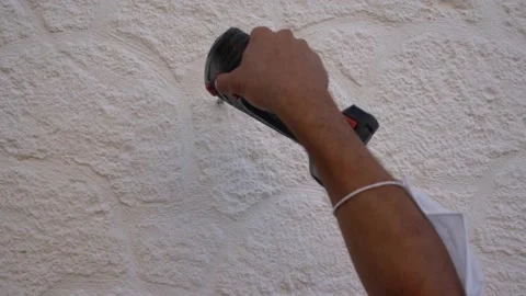 A large drill drills a hole in the wall.worker drills the wall with a drill. Stock Footage 133561840