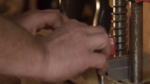 Large drill makes square hole in hardwood, throwing smoking chunks of wood Video stock 107670473