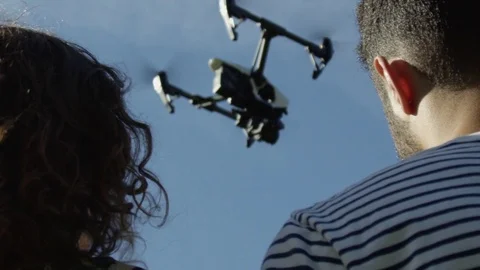 Large Drone Flying In Super Slow Motion Over the Shoulder of Two Fashionable Видео 82594083