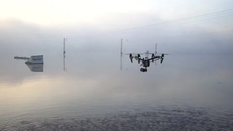 Large drone hovering over water on a foggy morning. jumps for wakeboarding  Video stock 142824565