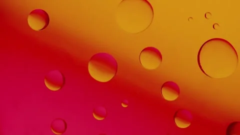 A large drop connects to a smaller drop on a red-yellow gradient background. Видео 303059182