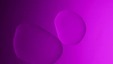 A large drop will connect with a smaller one on a purple gradient background 動画素材 303061139