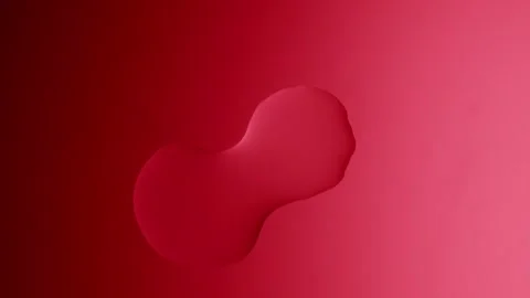 A large drop will connect with a smaller one on a red gradient background Видео 303061151