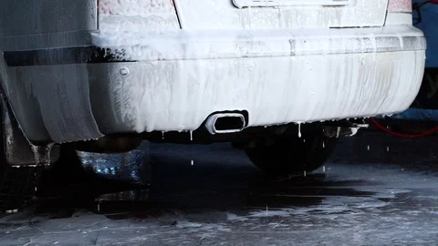 Large droplets of foam run off the gray machine to clean the machine of dirt. Ma Stock Footage 124125580