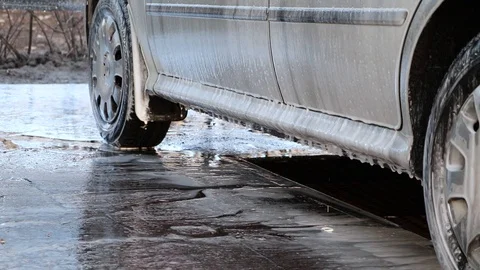 Large droplets of foam run off the gray machine to clean the machine of dirt. Ma Stock-Footage 124125611