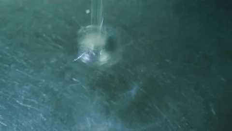 Large drops fall into the water one by one Stock Footage 145679527