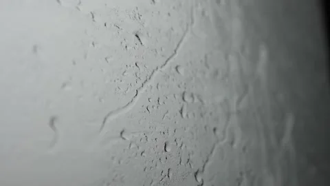 Large drops flow down the glass during the day Stock Footage 201267598