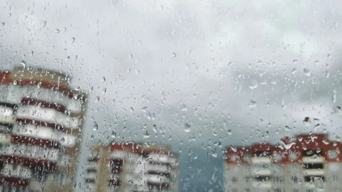 Large drops on glass. rain outside the window. Clouds. Sleeping area of the city Stock Footage 163556562
