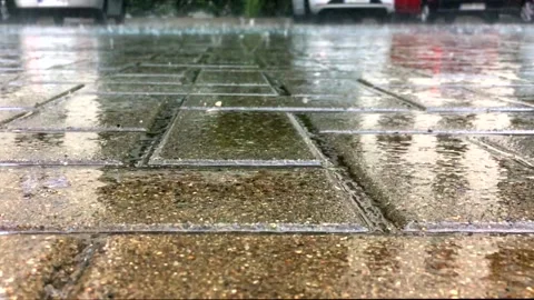 Large drops of heavy summer or autumn rain fall on the sidewalk in the city, flo Stock Footage 139678306
