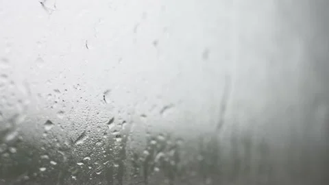 Large drops of rain flow down the glass during the day Stock Footage 201267578