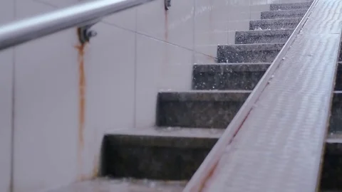Large drops of rain on the steps in the city turn into streams of water. HD Stock Footage 78157742
