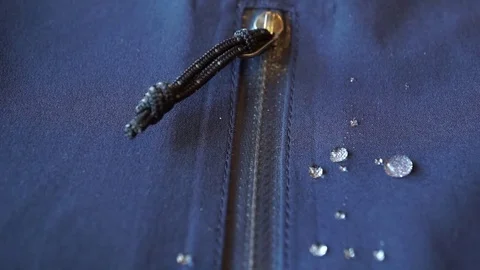 Large drops of water on waterproof clothes. zippers pocket fastener Stockbeeldmateriaal 78102346