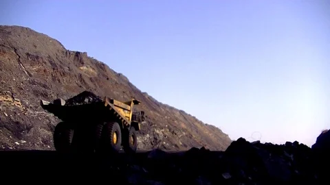 A large dump truck loaded with rocks. BelAZ.  dense morning fog Stock Footage 112990747