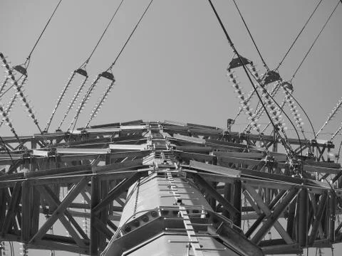 Large electric pole with wires against the blue sky black and white photo Stock Photos