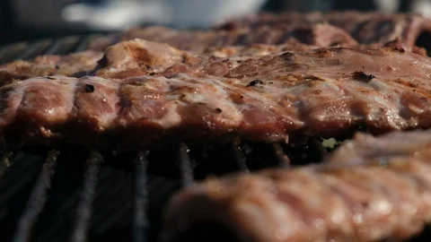 Large electric rotating grill for cooking ribs. The ribs rotate and are baked Stock Footage 115711547