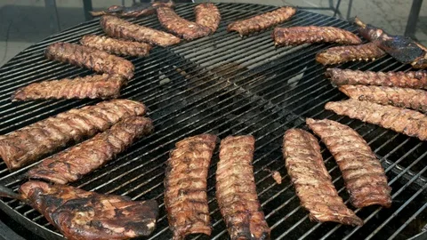 Large electric rotating grill for cooking ribs. The meat rotate and are baked Stock-Footage 129339273