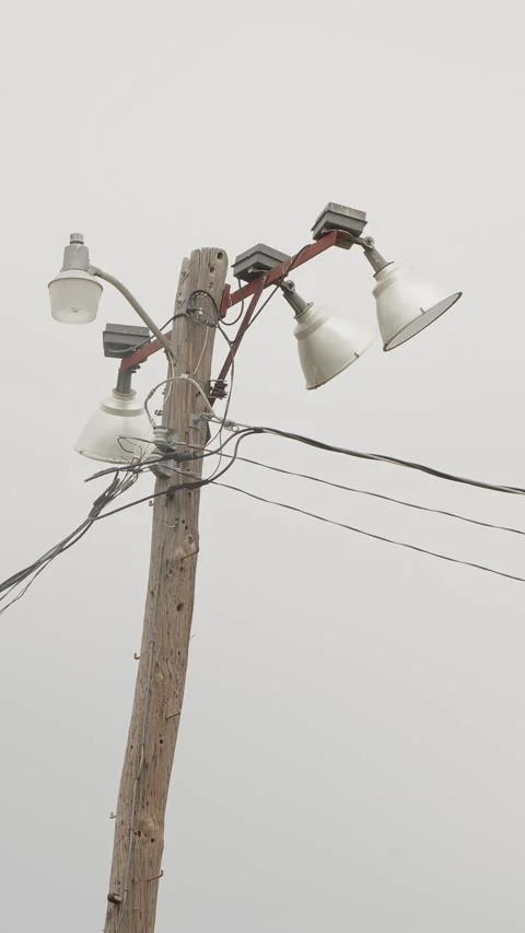 Large electrical floodlights used for lighting sports fields. Vertical Video stock 330488911