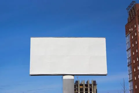 Large empty billboard layout on the sky background Stock Photos