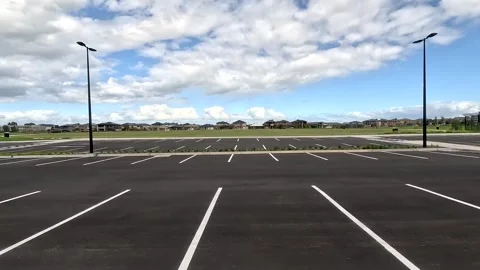 A large empty car park near a public green grass ground Point Cook Melbourne Stock Footage 273568064