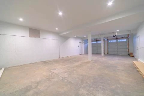 Large empty concrete garage interior doors lights Stock Photos