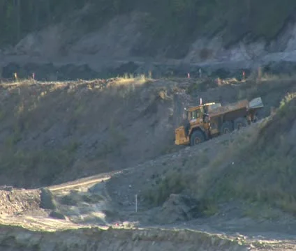 Large empty dump truck drives over dirt road Stock Footage 21562557