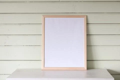 Large empty frame, a mockup, a stage creator. a white table in the cottage, a Foto stock