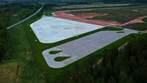 Large empty industrial park foundation and parking lot on gloomy day in aerial Stock-Footage 337090229