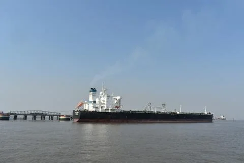 A large empty merchant ship waiting in mumbai port Stock Photos