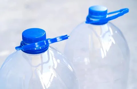 Large empty plastic bottle isolated on a blue background close-up. Stock Photos