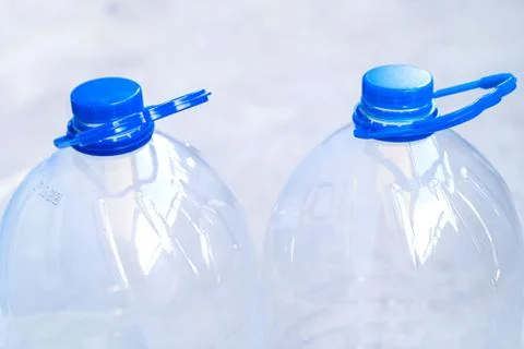 Large empty plastic bottle isolated on a blue background close-up. Stock Photos