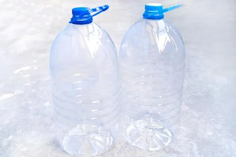 Large empty plastic bottle isolated on a blue background close-up. Stock Photos