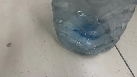 Large empty plastic water bottle container standing on floor 库存影片 336977081